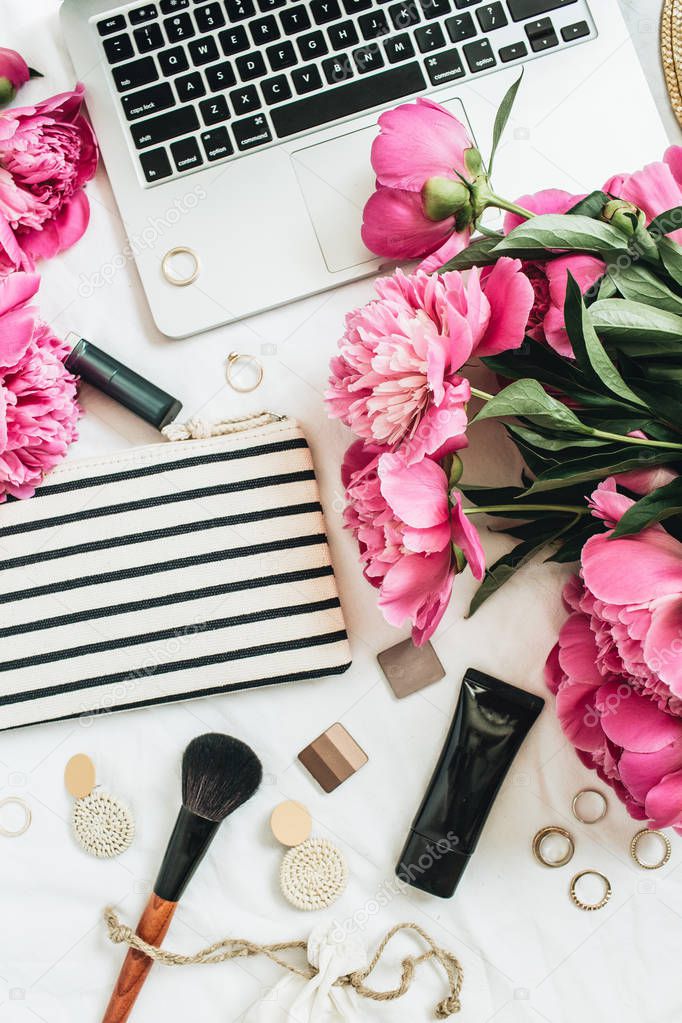 Flat lay, top view fashion women office desk with peony flowers, laptop, cosmetics, accessories on white background. Beauty of fashion blogger collage.