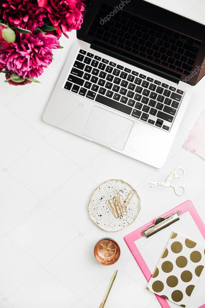 Flat lay workspace with laptop, accessories and peony flower bouquet on white background