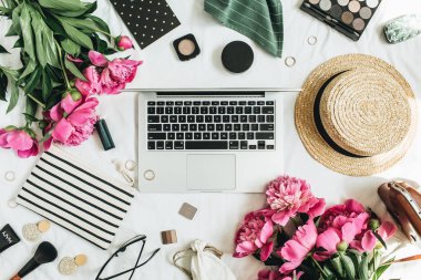 Düz yatıyordu, en iyi görünümü kadın moda ofis büro dizüstü şakayık çiçekleri, laptop, kozmetik, beyaz zemin üzerine aksesuarlar ile. Moda ya da güzellik blog yaşam tarzı kavramı.