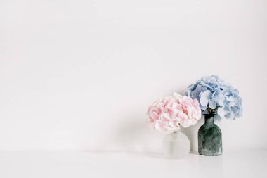 Pink and blue pastel hydrangea flower bouquets on white background. Minimal interior design concept. clipart