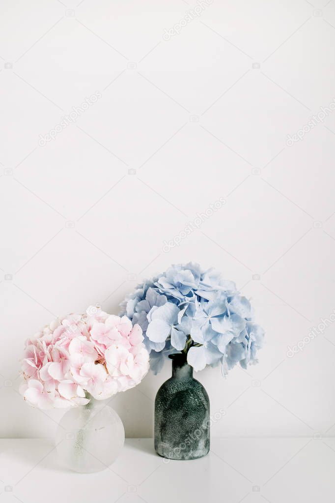 Pink and blue pastel hydrangea flower bouquets on white background. Minimal interior design concept.