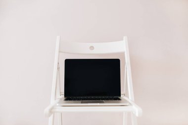 Laptop ekran masaüstü kadar boş sahte ile önden görünüm beyaz sandalye.