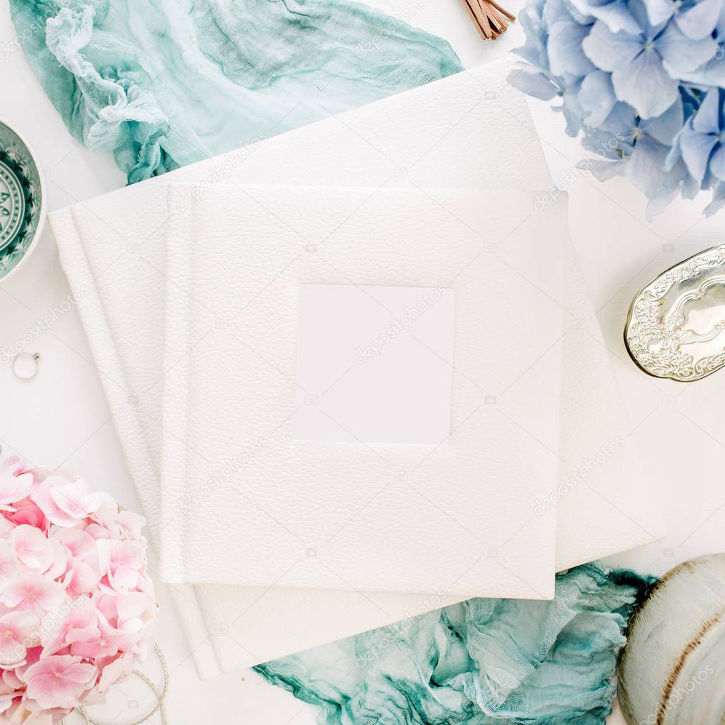 Family wedding photo album, pastel colorful hydrangea flower bouquet, turquoise blanket, decoration on white background. Flat lay, top view festive mockup.