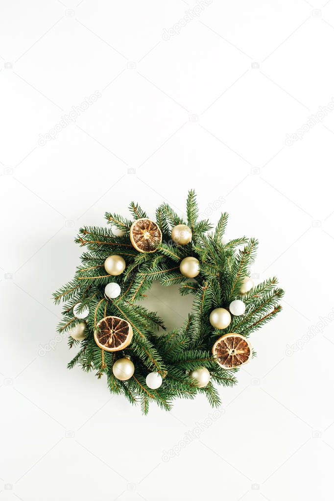 Christmas, New Year wreath frame made of fir branches decorated with dried oranges and Christmas balls. Flat lay, top view.