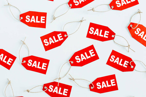 Состав скидок на распродажи "черной пятницы". Красные бирки со словом SALE на белом фоне. Плоский, вид сверху
.