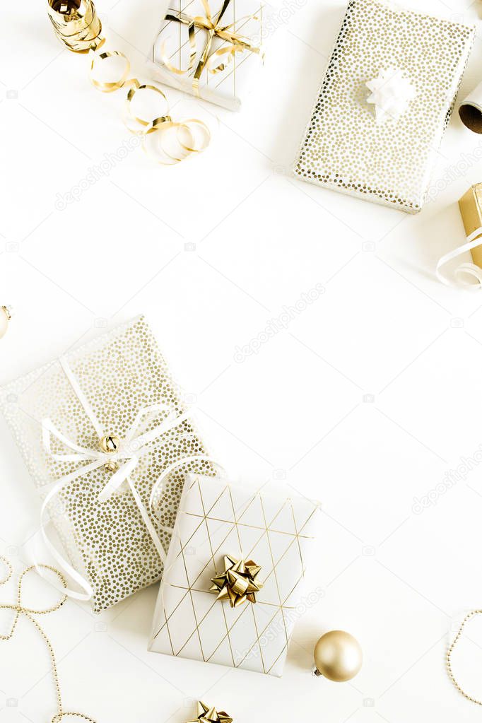Border frame mockup of golden gift boxes, decorations on white background. Flat lay, top view Christmas, New Year holiday gifts packaging concept.