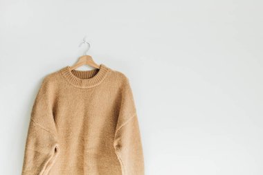 Kadın yün kazak beyaz zemin üzerine izole askı kazak üzerine yakın çekim. Kadın moda giysiler kavramı