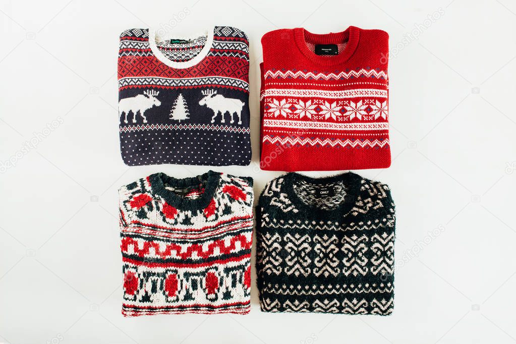 Warm woolen sweaters collage on white background. Flat lay, top view Christmas, New Year, Winter fashion concept.