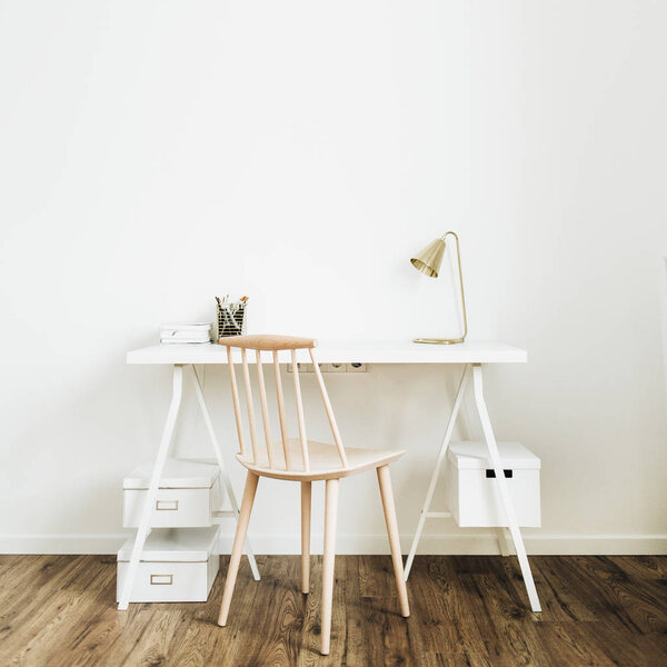 Bright home office desk workspace. Nordic modern minimal interior design concept. Desktop table and wooden chair in white room.