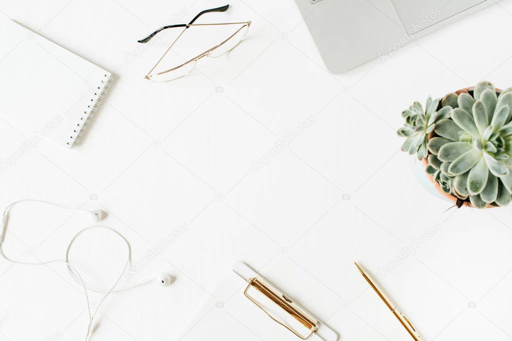 Round frame of home office desk workspace with blank copy space mock up clipboard, laptop, headphones, glasses, succulent on white background. Flat lay, top view modern minimal hero header.