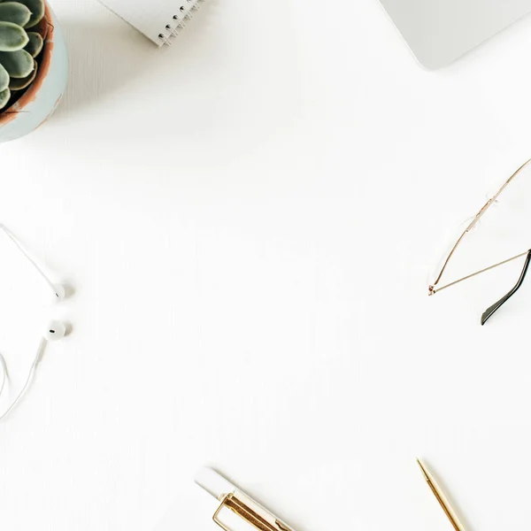 Round frame of home office desk workspace with blank copy space mock up clipboard, laptop, headphones, glasses, succulent on white background. Flat lay, top view modern minimalist blog template.