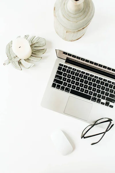 Minimal home office desk workspace with laptop, glasses on white background. Flat lay, top view lifestyle blog template.
