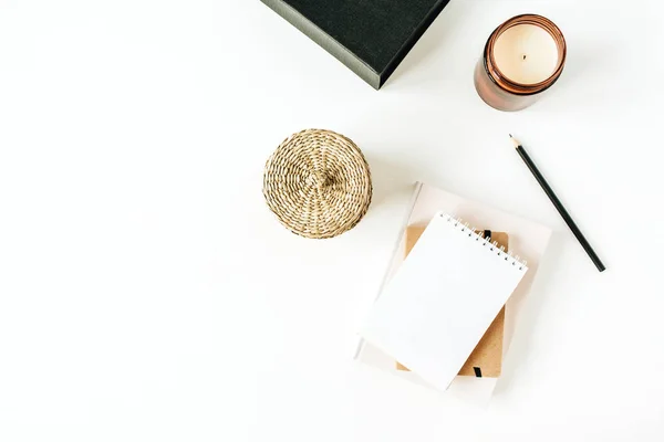 Minimalist office desk workspace with notebook on white background. Flat lay, top view blank paper copy space mock up.