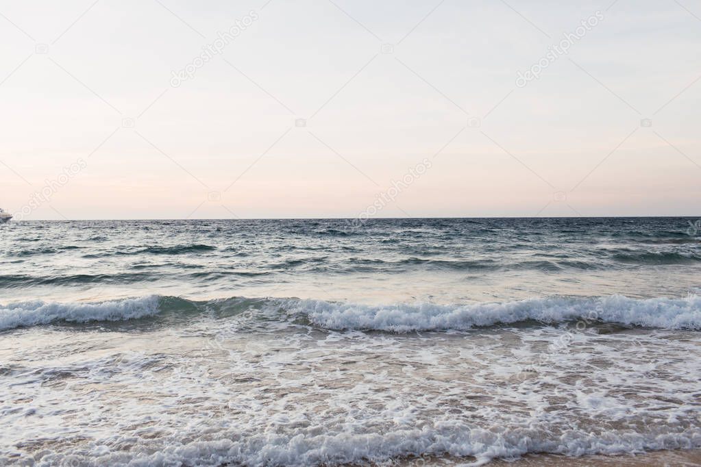 Beautiful tropical beach and water view with  blue sea or ocean with waves on Phuket, Thailand. Minimal composition with punchy colors. Summer concept. Natural background.