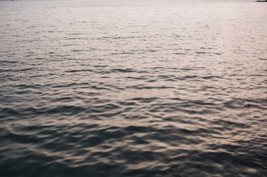 Deniz veya okyanus suyu ile biraz rahatlatıcı dalgalar ve farklı ışık yansıması. Kremsi pembe ve koyu mavi renklerile güzel degrade. Nötr arka plan ve doku.