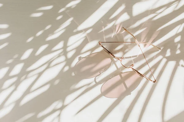 Óculos Sol Rosa Feminino Mesa Branca Com Sombra Floral Fundo — Fotografia de Stock
