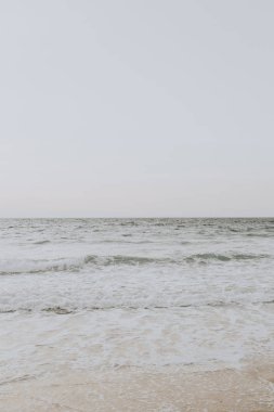 Phuket, Tayland dalgalar ile beyaz kum ve bej deniz ile güzel tropikal plaj manzarası. Nötr renklerle minimal kompozisyon. Yaz konsepti. Doğal arka plan.