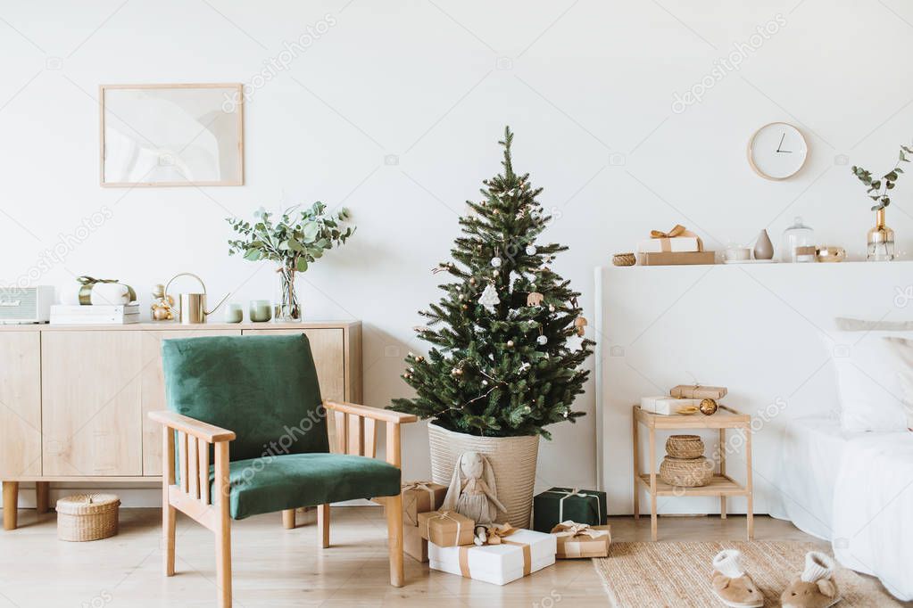 Modern interior design living room with Christmas / New Year decorations, toys, gifts, fir tree. Winter holidays composition.