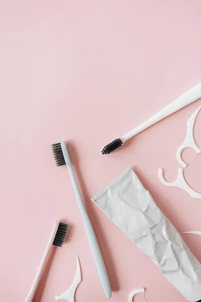 Toothbrushes Toothpaste Tooth Flossers Pink Background Flat Lay Top View — Stock Photo, Image