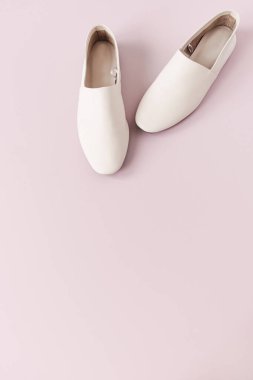 Fashion collage with women's white leather slippers on pink. Minimal flat lay, top view lifestyle concept. clipart