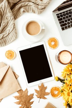 Ofis masası çalışma alanı. Kopya alanı olan boş ekran tableti. Sarı papatya çiçeği buketi, portakal dilimleri. Düz konum, üst görünüm serbest iş konsepti sosyal medya, dergi.