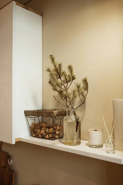 Kitchen interior design decorated with fir branch in vase. Christmas / New Year celebration decorations.