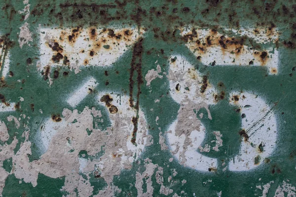 number thirty five painted on rusty green metal, number 35