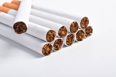Beyaz arkaplanda filtreli sigara yığını