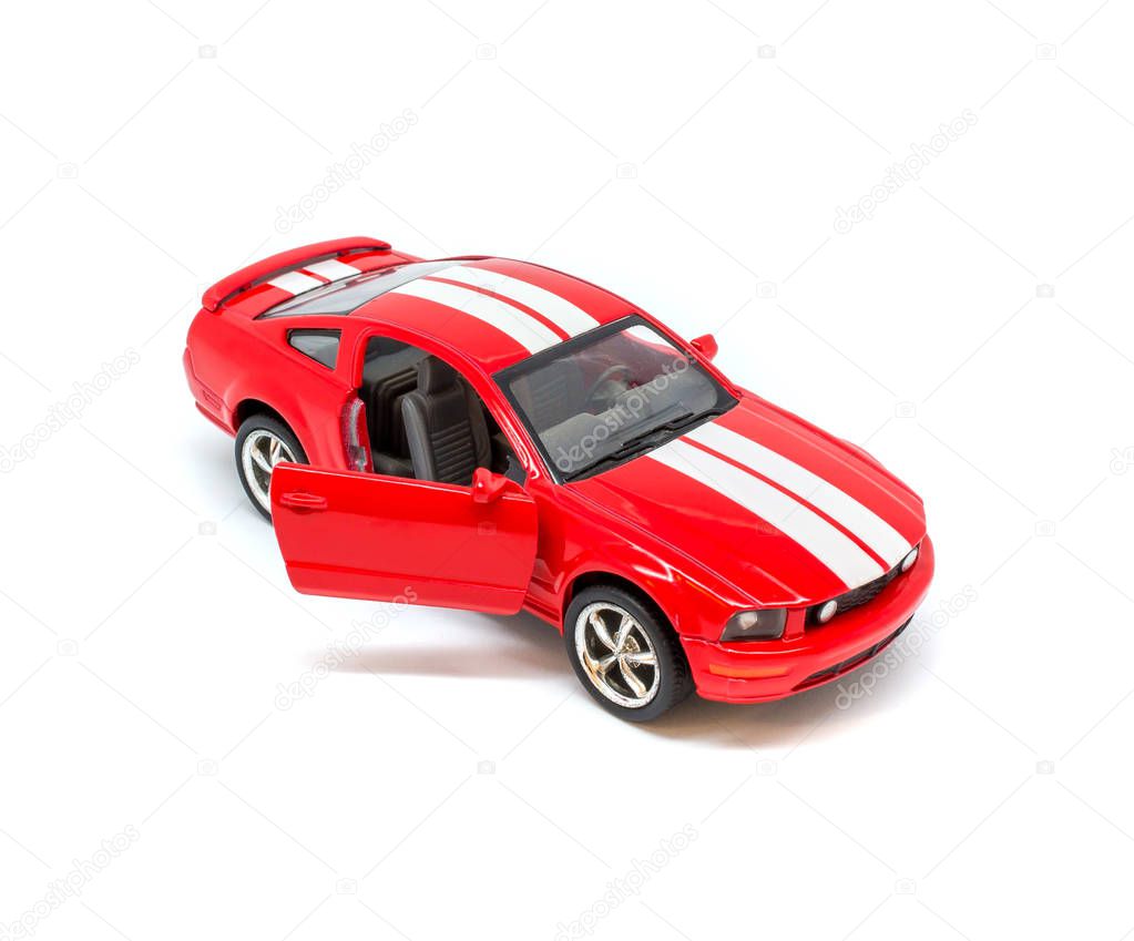 Photo of small red toy model car isolated on white background