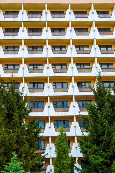 Photo of orange white modern apartment building with mesh look — Stock Photo, Image