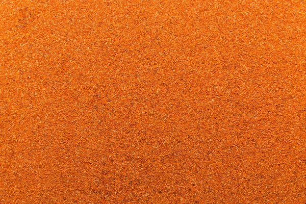 Foto de close up textura de especiarias quentes de pimenta vermelha para diferentes alimentos, fundo — Fotografia de Stock