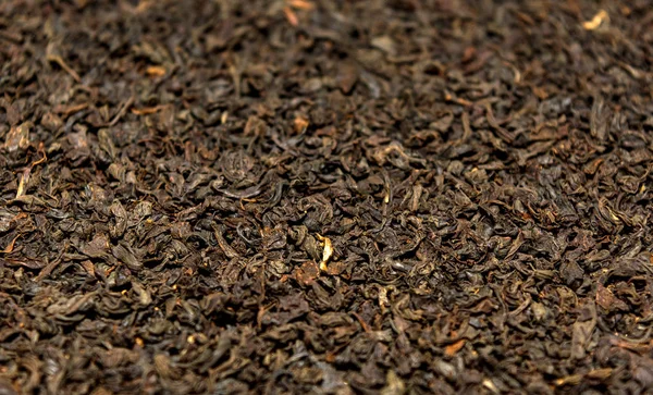 Foto de close up textura de chá preto seco, fundo — Fotografia de Stock