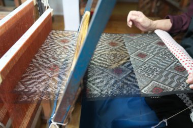 Amami Oshima, Japan - April 6, 2019: Weaving Oshima Tsumugi made of silk thread. Traditional pongee in Amami Oshima.  clipart