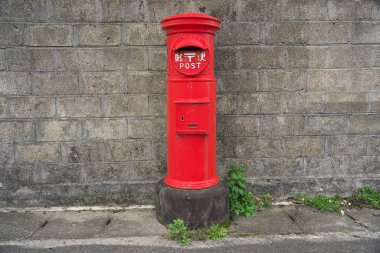 Amami Oshima, Japan - April 6, 2019: Red Post Box in Amami Oshima, Kagoshima, Japan clipart