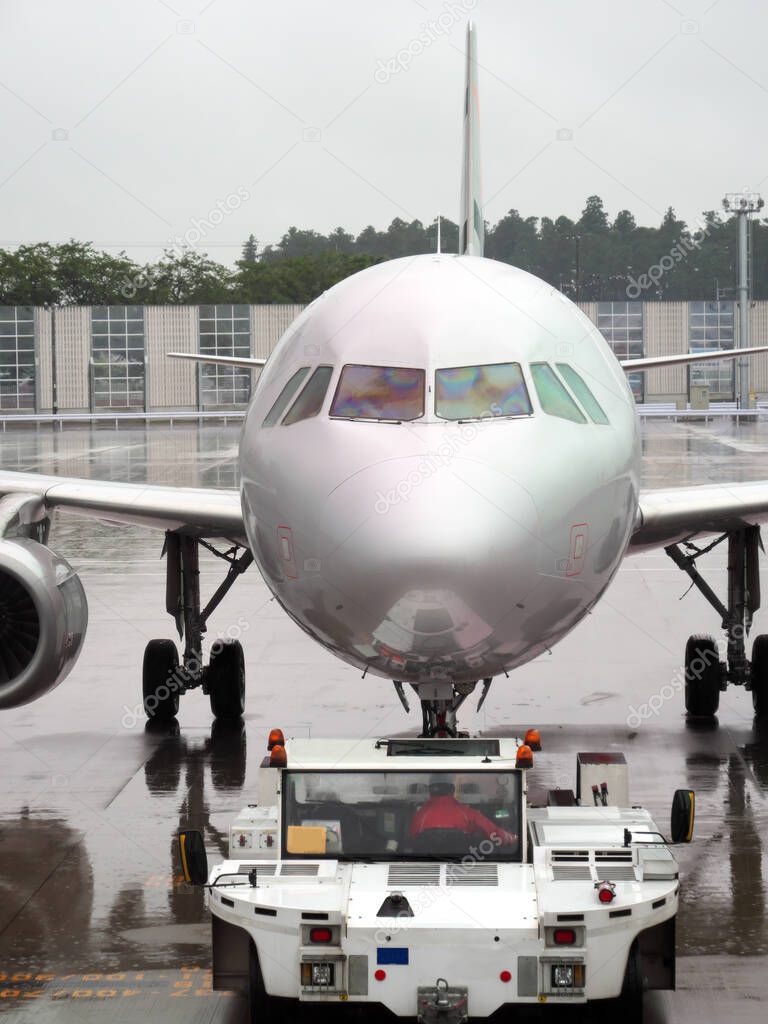 Chiba,Japan-June 19, 2020:Towing Car just starting to pull an aircraft from the terminal