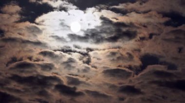 Hızlı hareket eden karanlık bulutların arasından güneş diski bakıldı.