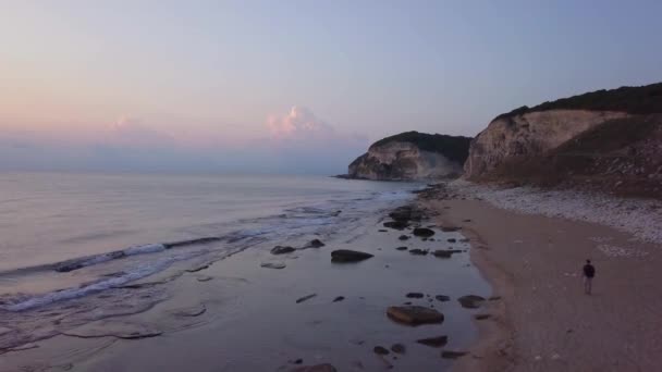 Воздушный Вид Восход Солнца Песчано Каменном Пляже Человек Идущий Пляжу — стоковое видео