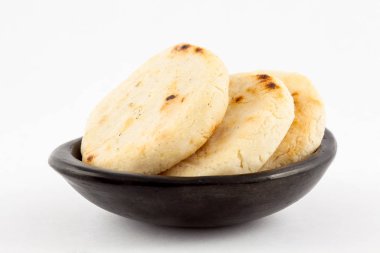 Kavrulmuş geleneksel Güney Amerika Mısır arepa beyaz arka plan üzerinde siyah bir seramik tabak