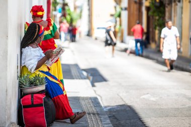 CARTAGENA DE INDIAS, COLOMBIA - AUGUST, 2018: Traditional fruits street vendor in Cartagena de Indias called Palenquera clipart