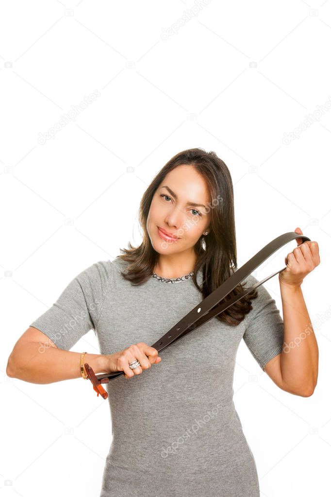 Angry young mother with belt on her hands