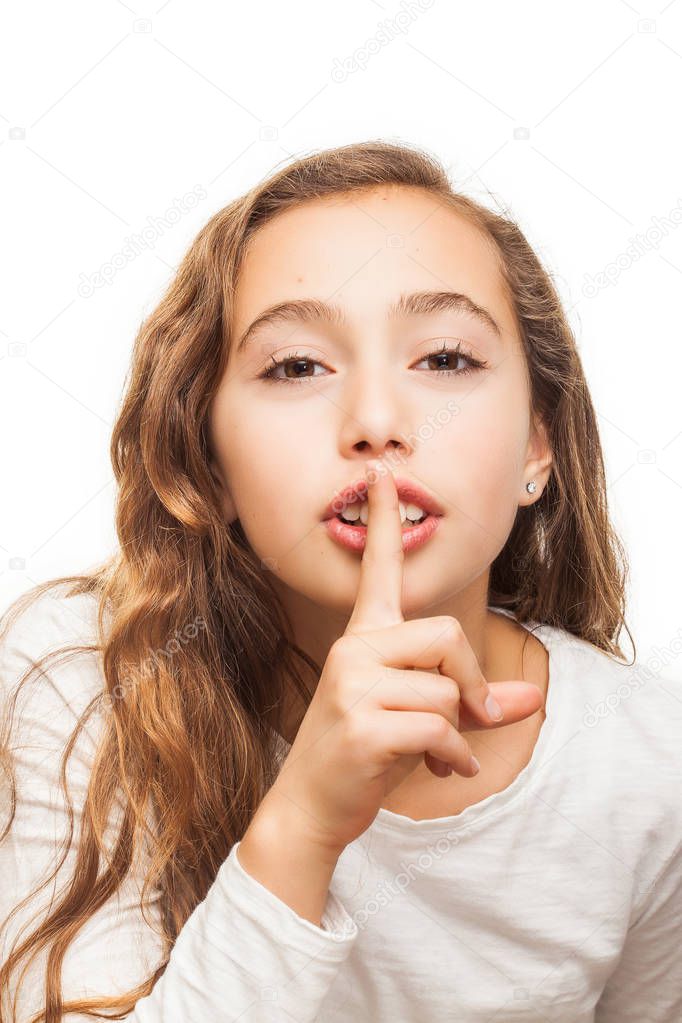 Young girl with holding finger on her lips on silence gesture isolated on white background