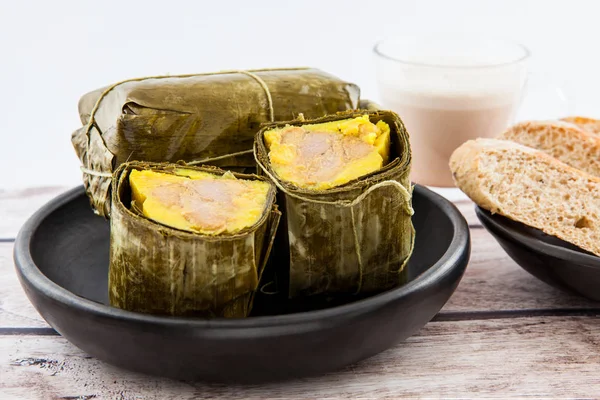 Traditional Colombian tamale breakfast with bread and chocolate as made on Santander region isolated on white background — Stock Photo, Image