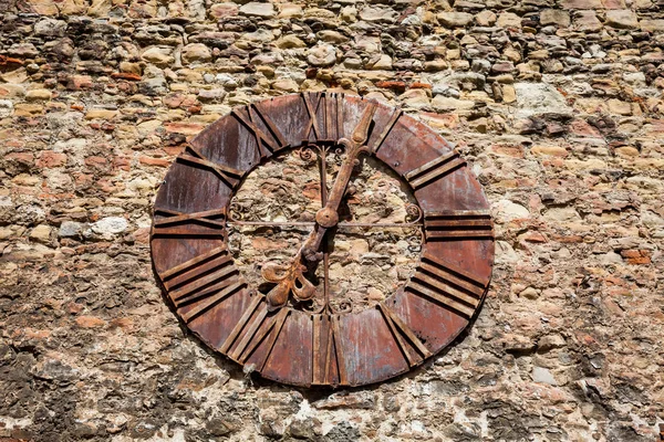 Wall of the Kaptol fortress and the Antique rusty clock removed from the Zagreb Cathedral showing 7:03 hours the exact  time when the big earthquake hit Zagreb in 1880 Royalty Free Stock Images