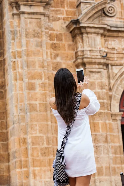 Hermosa mujer tomando fotos de la iglesia de San Pedro Claver ubicada en la ciudad amurallada de Cartagena de Indias — Foto de Stock