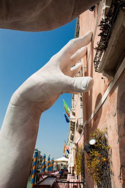 VENICE, ITALY - APRIL, 2018: Hands sculpture created by Spanish artist Lorenzo Quinn in the Venice Grand Canal to call attention about the negative effects of climate change clipart
