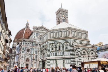 Tourists visiting the historical Baptistery of St. John, Giotto Campanile and Florence Cathedral consecrated in 1436 clipart