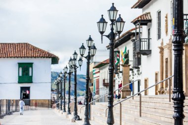 Beautiful streets and houses around Bolivar Square in Tunja city clipart