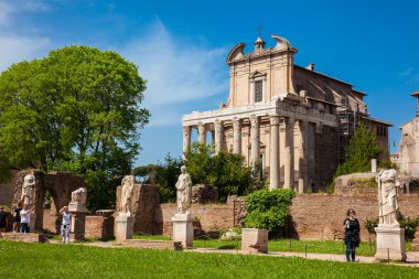 Tourists visiting the ancient ruins of the House of the Vestal Virgins at the Roman Forum in Rome clipart