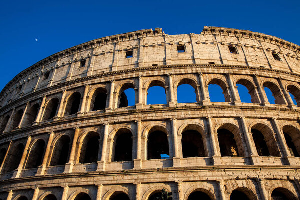 The famous Colosseum under the beautiful light of the golden hour in Rome