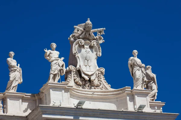 Dettaglio degli stemmi Chigi e delle statue di santi che incoronano i colonnati di Piazza San Pietro costruiti nel 1667 sulla Città del Vaticano — Foto Stock